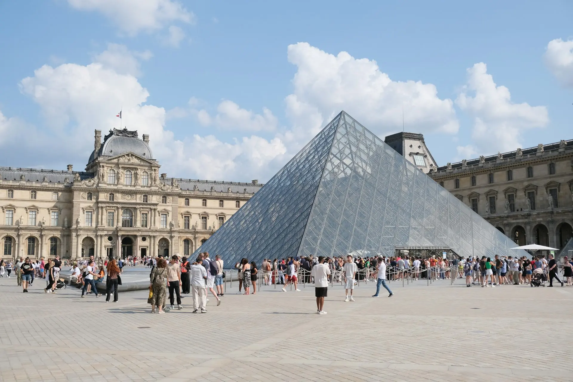 A group of people standing around a large pyramid